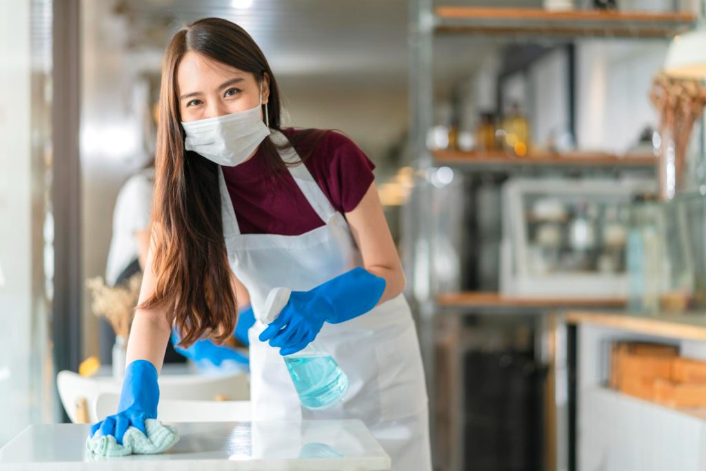 maid cleaning a table